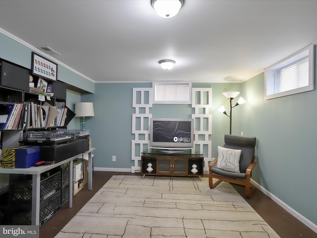 interior space with crown molding, wood finished floors, visible vents, and baseboards