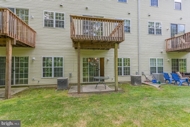 rear view of property with a patio area, a lawn, and central air condition unit