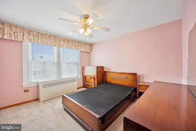 bedroom featuring carpet, radiator, ceiling fan, and baseboards