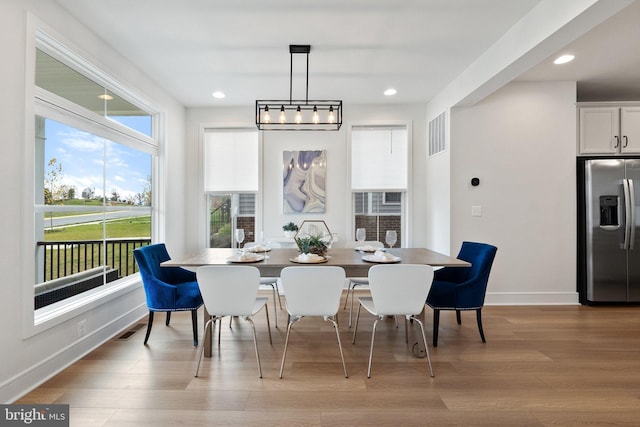 dining area with light wood finished floors, recessed lighting, visible vents, and baseboards