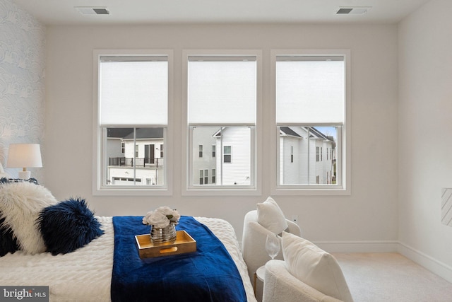 carpeted bedroom with visible vents, baseboards, and wallpapered walls