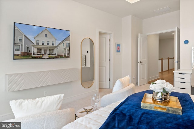 bedroom with light carpet and baseboards