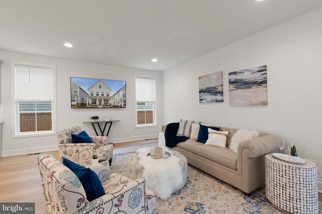 living room with recessed lighting, baseboards, and light wood finished floors