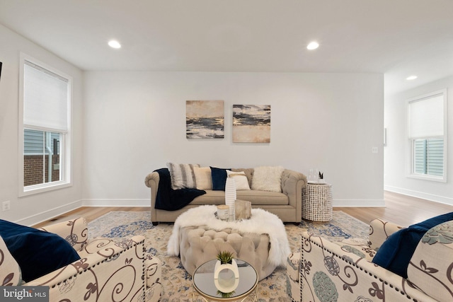 living area featuring plenty of natural light, light wood-type flooring, and recessed lighting