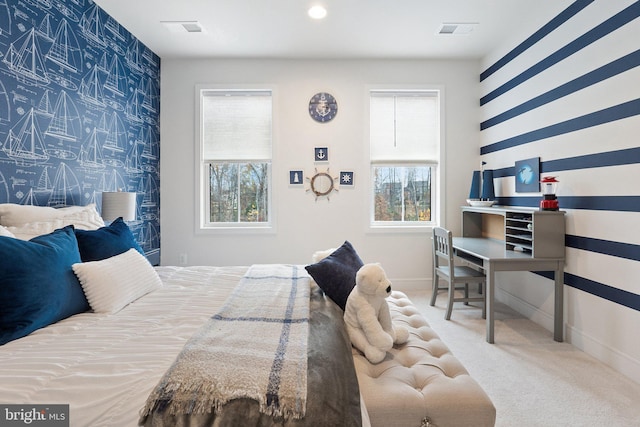 carpeted bedroom with wallpapered walls, an accent wall, and multiple windows