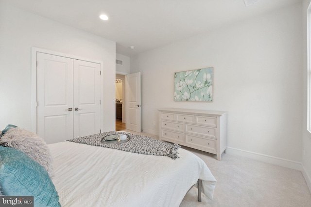 bedroom with visible vents, baseboards, light colored carpet, a closet, and recessed lighting