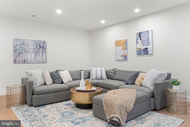 living area with recessed lighting, baseboards, and light wood finished floors