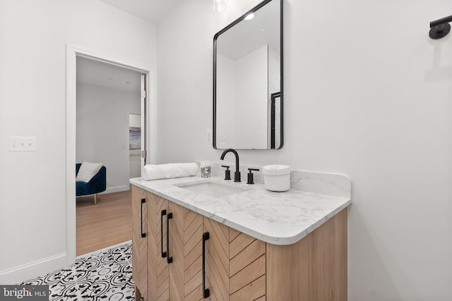 bathroom featuring baseboards and vanity