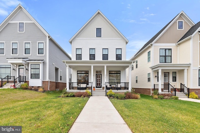 view of front facade with a porch, board and batten siding, and a front yard