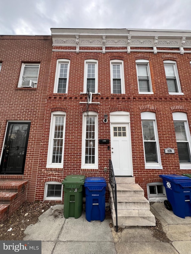 townhome / multi-family property featuring entry steps and brick siding