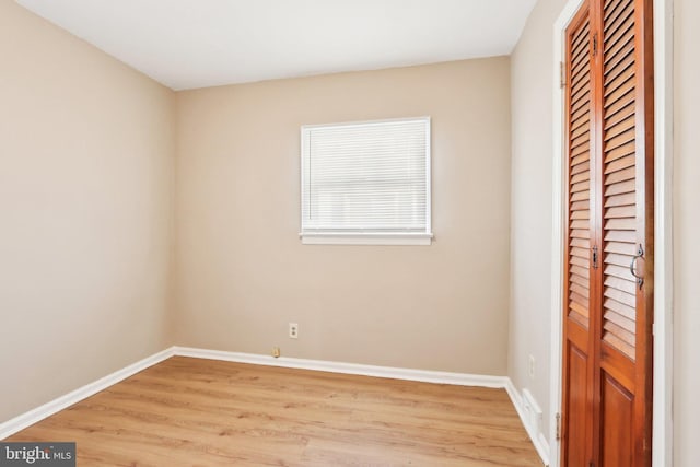 unfurnished room featuring light wood-style flooring and baseboards