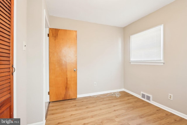 unfurnished bedroom with baseboards, visible vents, and light wood finished floors