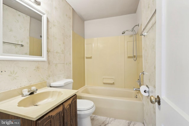 bathroom featuring tub / shower combination, vanity, toilet, and wallpapered walls