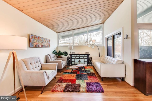 living room featuring wooden ceiling, baseboards, and wood finished floors