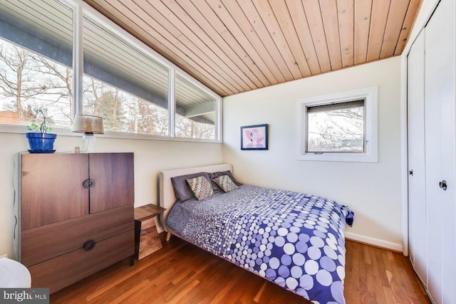 bedroom with wood ceiling, baseboards, vaulted ceiling, and wood finished floors