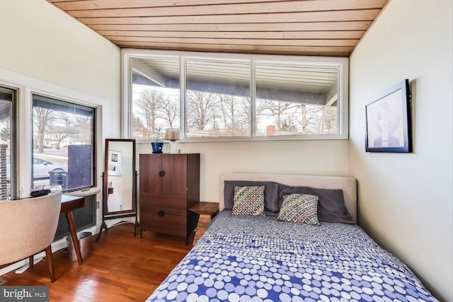 bedroom with wooden ceiling and wood finished floors