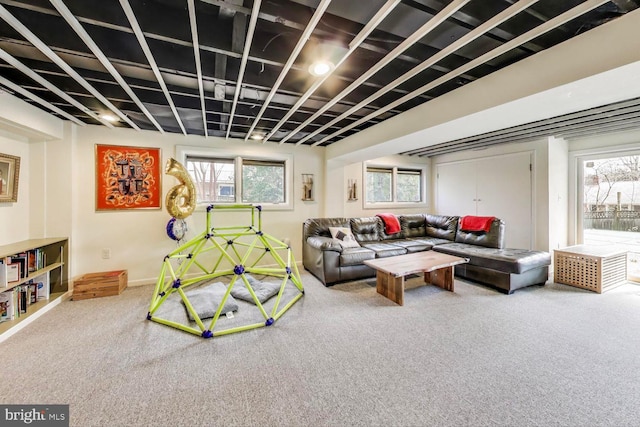 carpeted living room with baseboards and a healthy amount of sunlight