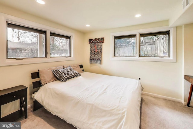 carpeted bedroom featuring recessed lighting, visible vents, and baseboards