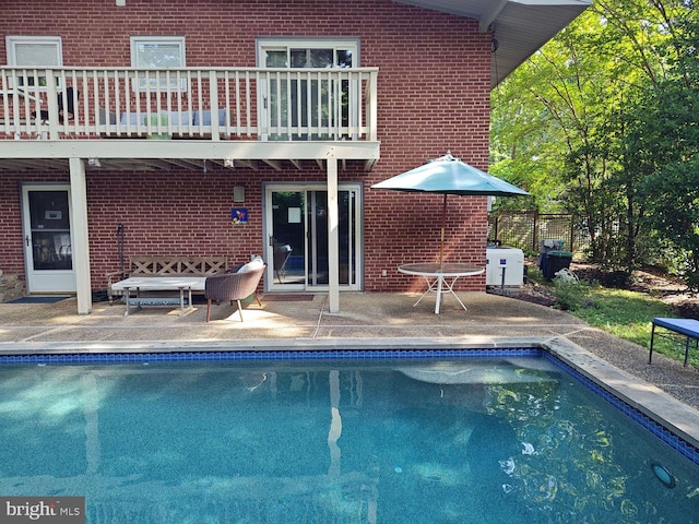 pool with fence and a patio