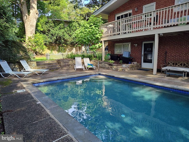 view of pool featuring a patio area, fence, and a fenced in pool