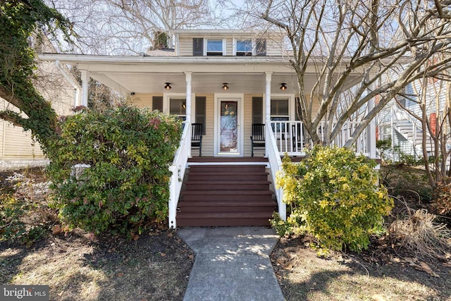 view of front of home featuring stairs and a porch