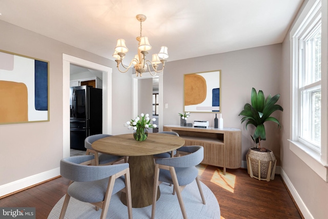 dining area with a healthy amount of sunlight, dark wood-type flooring, and baseboards