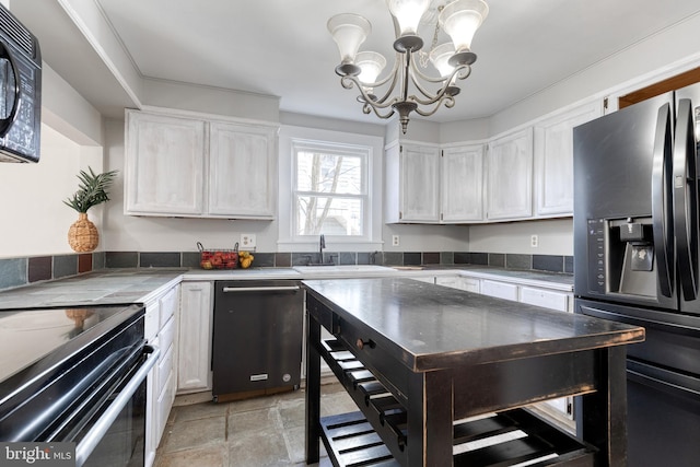 kitchen with tile countertops, a sink, black appliances, white cabinets, and a chandelier