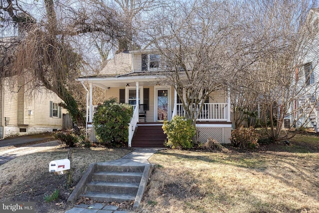 view of front of property with stairway and covered porch