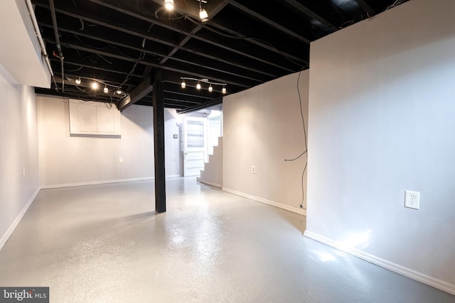 basement with stairway and baseboards