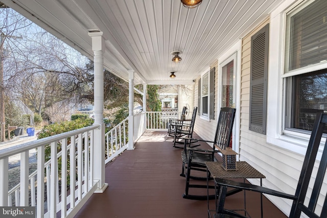 wooden terrace featuring covered porch