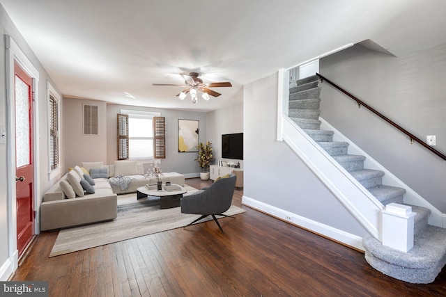 living area featuring baseboards, visible vents, ceiling fan, stairs, and wood-type flooring