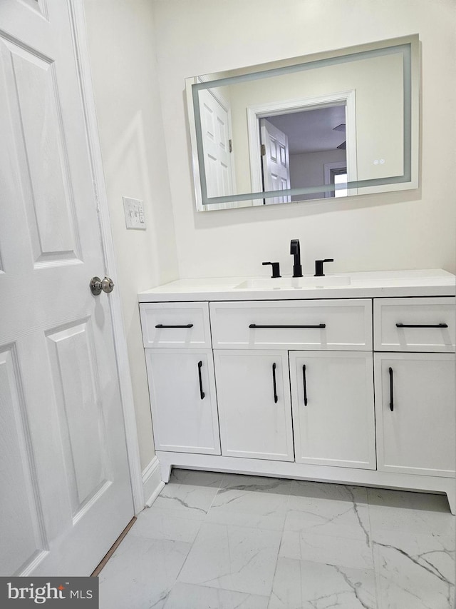 bathroom featuring marble finish floor and vanity