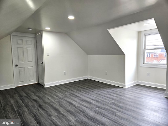 bonus room featuring dark wood-style floors and baseboards
