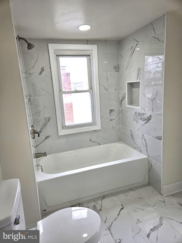 full bathroom featuring marble finish floor, shower / bath combination, and toilet