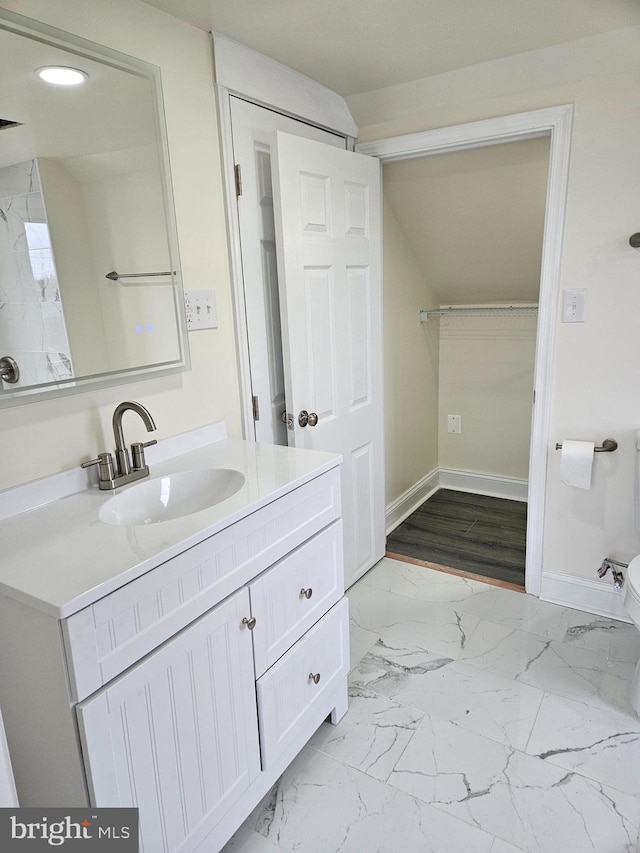 bathroom featuring toilet, recessed lighting, vanity, baseboards, and marble finish floor