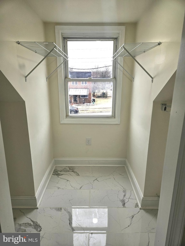 spacious closet featuring marble finish floor