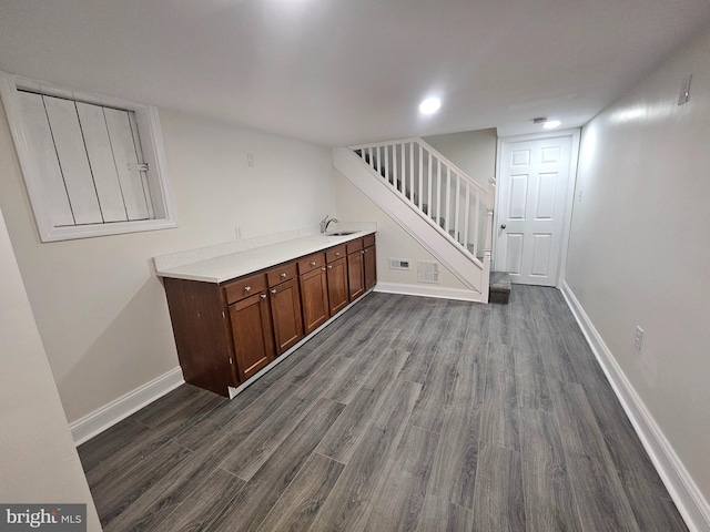 bar with baseboards, visible vents, stairway, and dark wood-style flooring