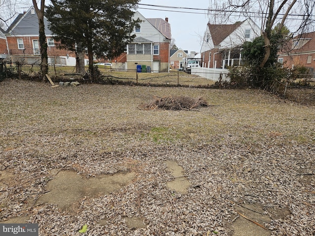 view of yard with fence and a residential view