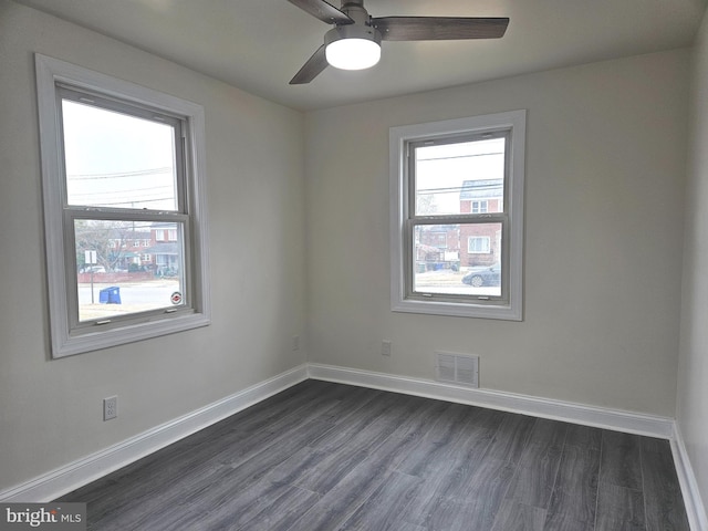 unfurnished room with visible vents, plenty of natural light, and baseboards