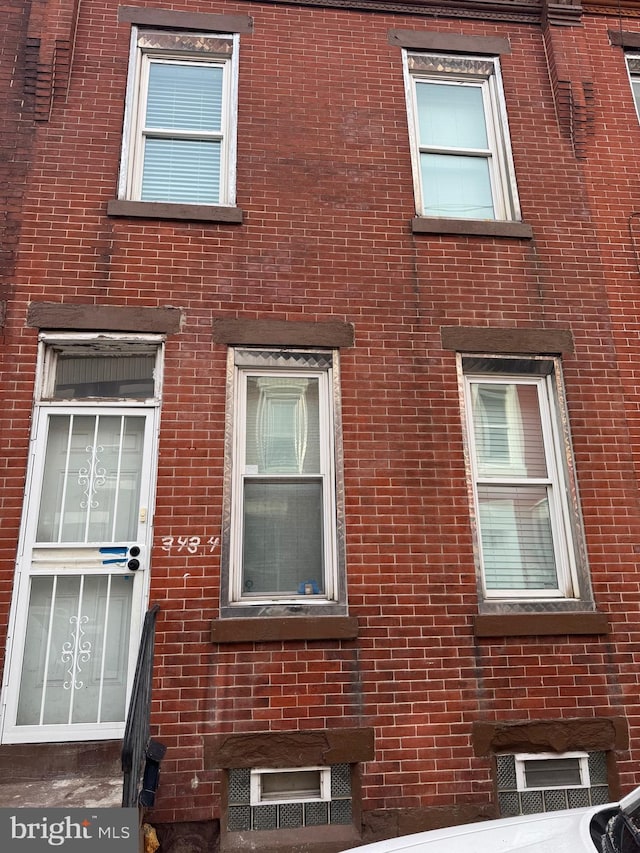 view of property exterior with brick siding