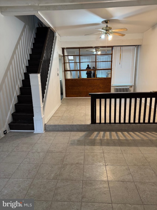 stairs with a ceiling fan