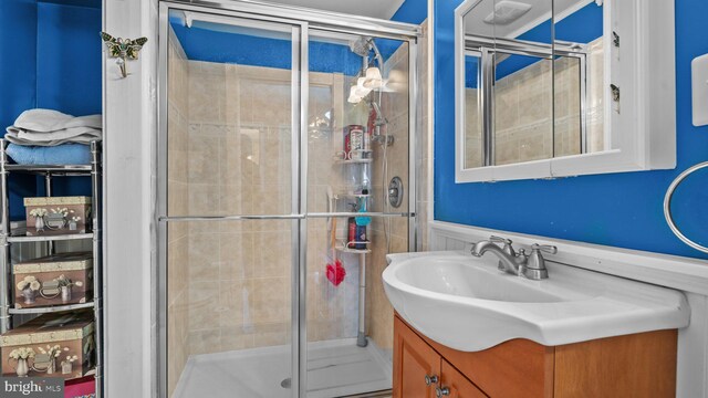 bathroom featuring a shower stall and vanity