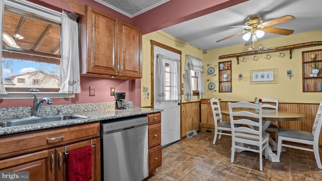 kitchen with a sink, light countertops, a wealth of natural light, dishwasher, and brown cabinetry