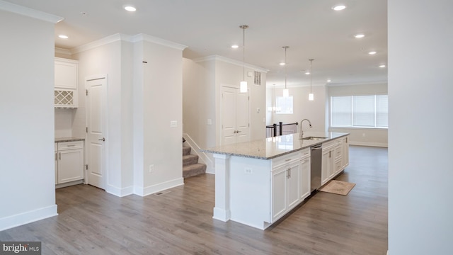 kitchen with a sink, white cabinetry, dishwasher, and wood finished floors