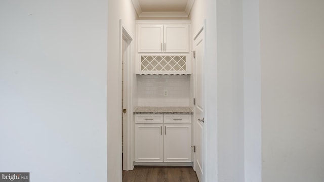 interior space with ornamental molding and dark wood finished floors