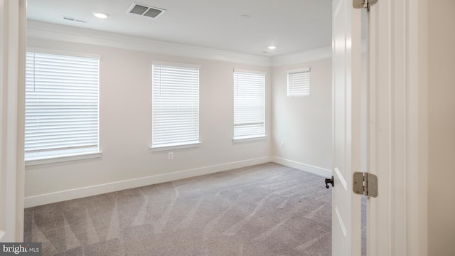 empty room featuring baseboards, visible vents, crown molding, carpet flooring, and recessed lighting