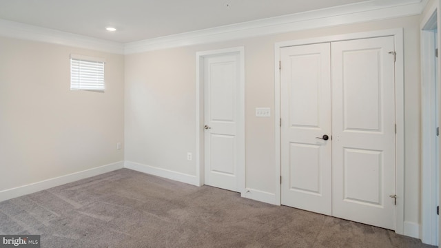 unfurnished bedroom featuring baseboards, ornamental molding, carpet flooring, a closet, and recessed lighting