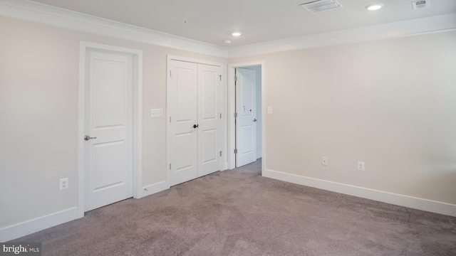 unfurnished bedroom with crown molding, recessed lighting, visible vents, carpet flooring, and baseboards