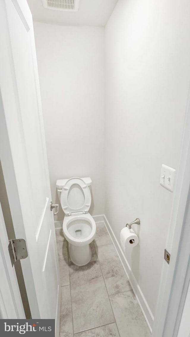 bathroom with visible vents, toilet, and baseboards