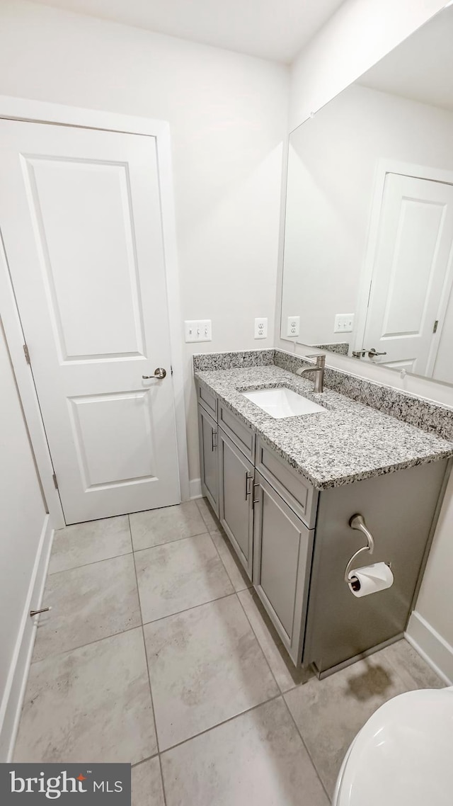 bathroom with vanity and baseboards